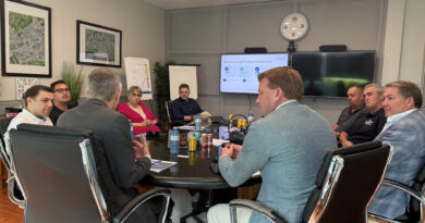 A photo of a meeting at a board table.