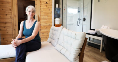 A woman poses in a hydrotherapy room.