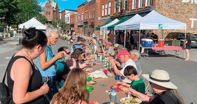 People eat at a table outside.