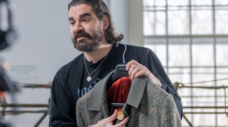 A man holds a jacket.