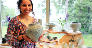 A woman holds her art.