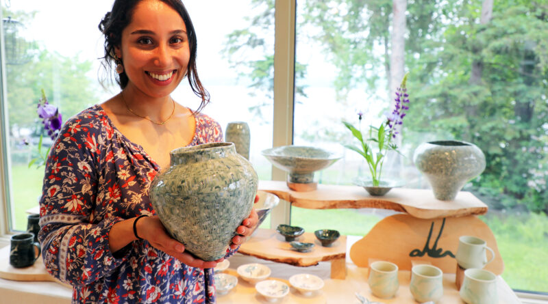A woman holds her art.