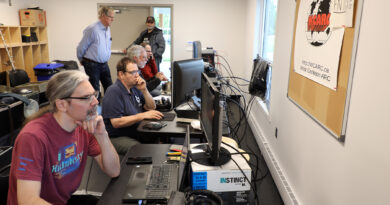 A photo of people using radio equipment.