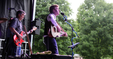 A band performs in a park.