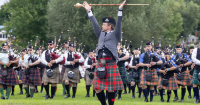 A Pipes and Drums band performs.